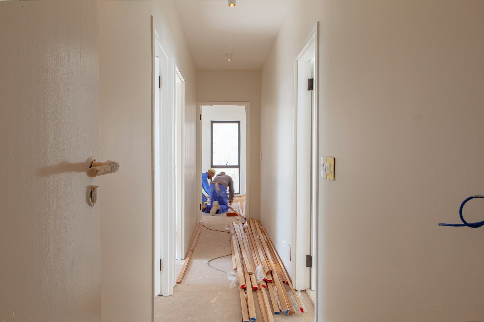 a couple of men working on a house